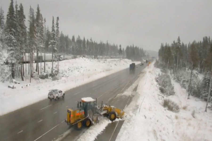 In this image from a Caltrans remote traffic video camera, snow is cleared from a shoulder lane along Interstate 80 at Donner Summit, Calif., Oct. 18, 2021. (Caltrans via AP)