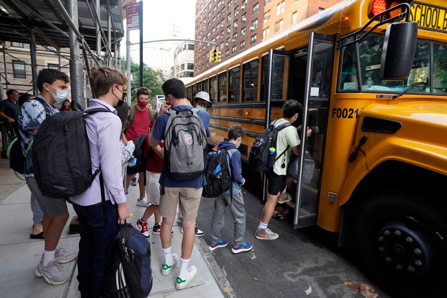 In this Sept. 13, 2021, file photo, students board a school bus on New York's Upper West Side. (AP Photo/Richard Drew, File)