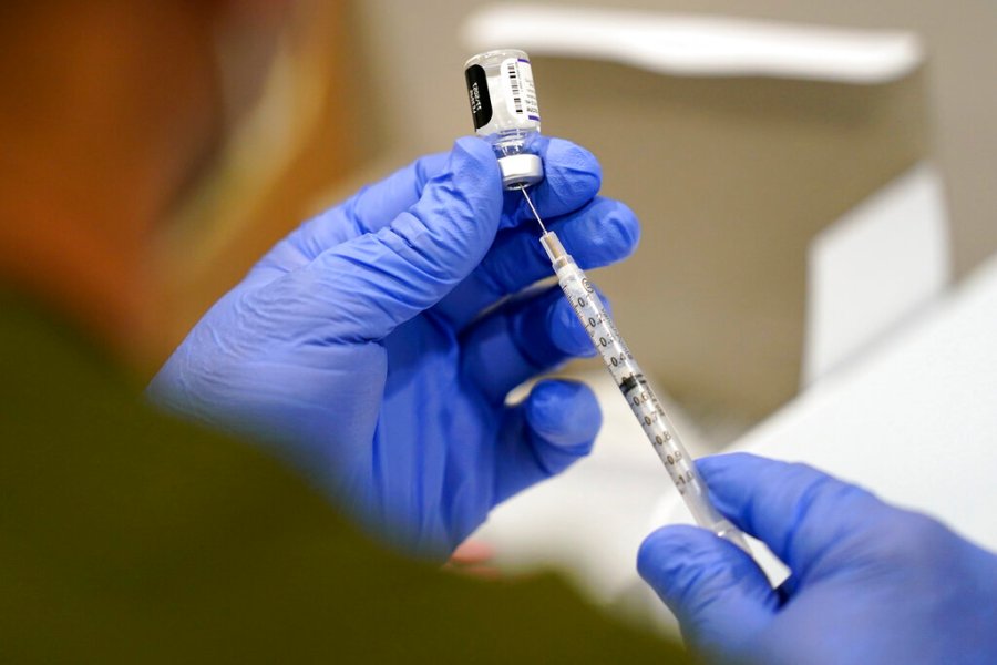 In this Oct. 5, 2021, file photo a healthcare worker fills a syringe with the Pfizer COVID-19 vaccine at Jackson Memorial Hospital in Miami. (AP Photo/Lynne Sladky, File)