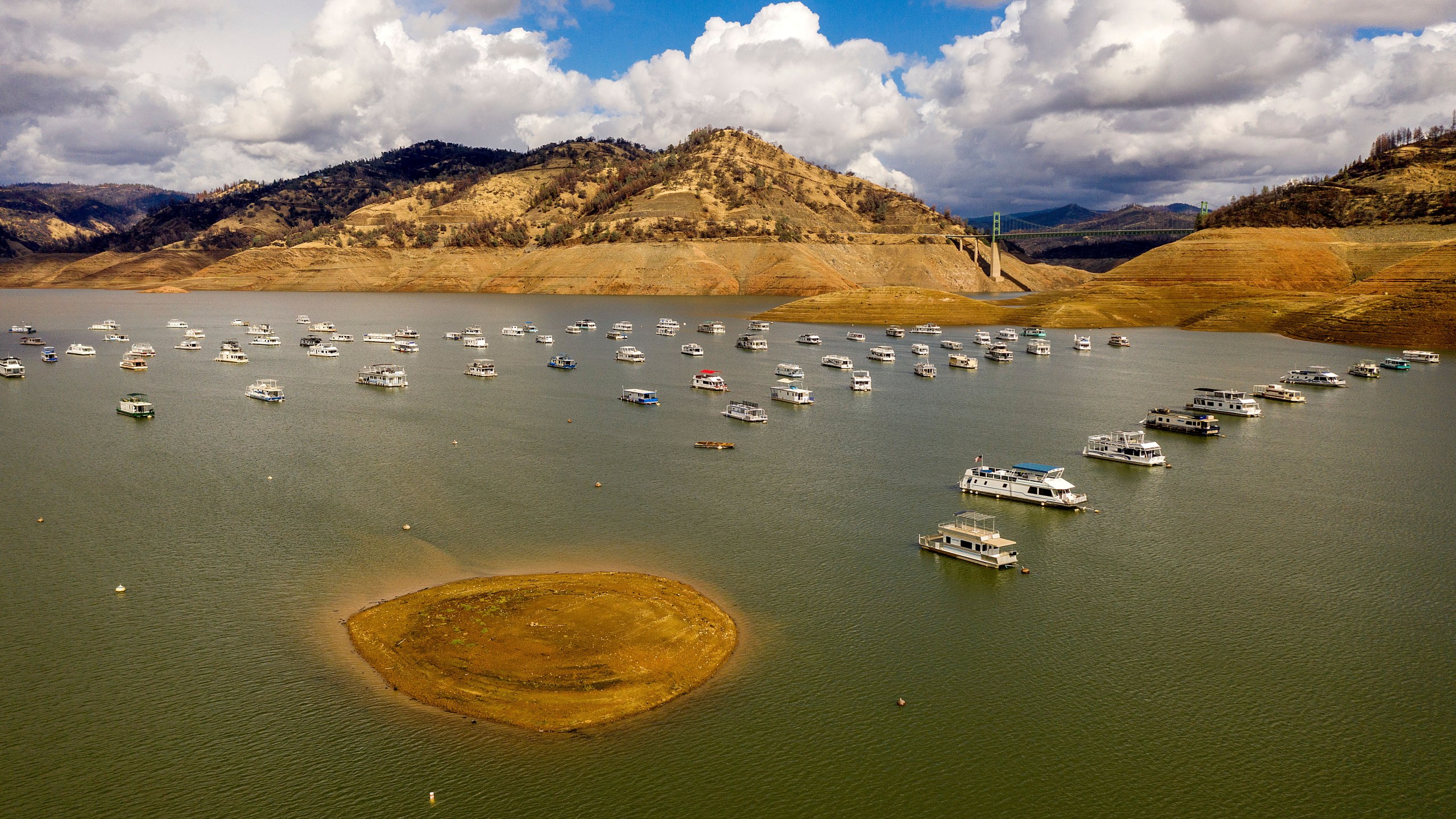 Houseboats float on Lake Oroville, Monday, Oct. 25, 2021, in Oroville, Calif. Recent storms raised the reservoir more than 16 feet, according to the California Department of Water Resources. (AP Photo/Noah Berger)