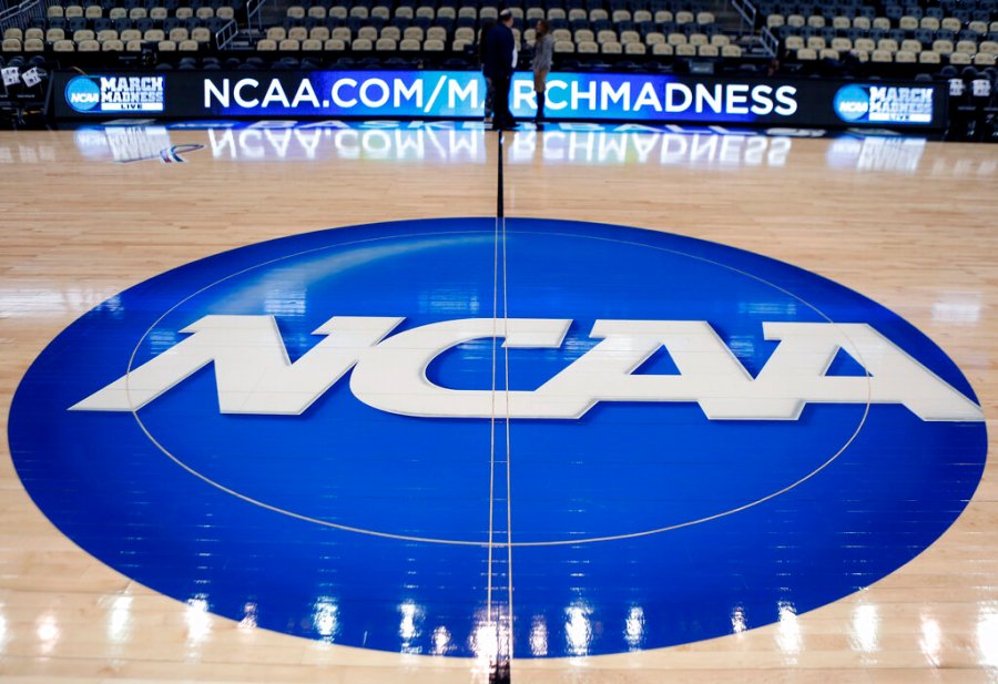 In this March 18, 2015, file photo, the NCAA logo is displayed at center court as work continues at The Consol Energy Center in Pittsburgh, for the NCAA college basketball tournament. (AP Photo/Keith Srakocic, File)