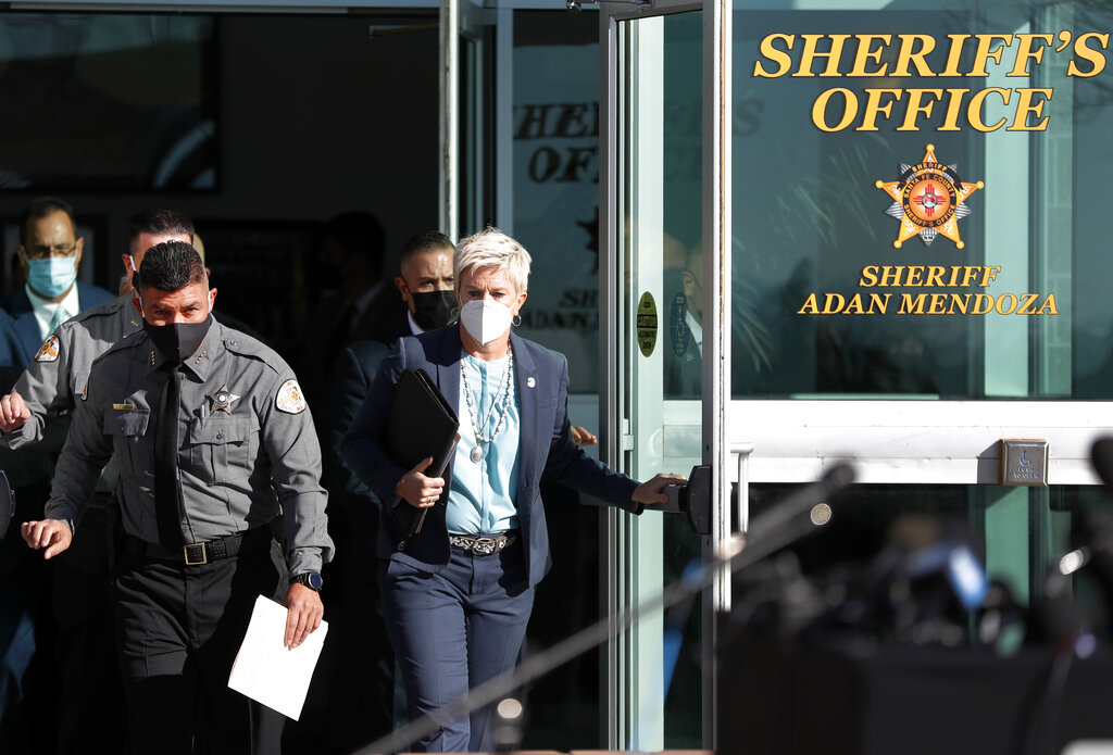 Santa Fe County Sheriff Adan Mendoza, left, and Santa Fe District Attorney Mary Carmack-Altwies exit the sheriff's office to address the media at a news conference in Santa Fe, N.M. Wednesday, Oct. 27, 2021. (AP Photo/Andres Leighton)