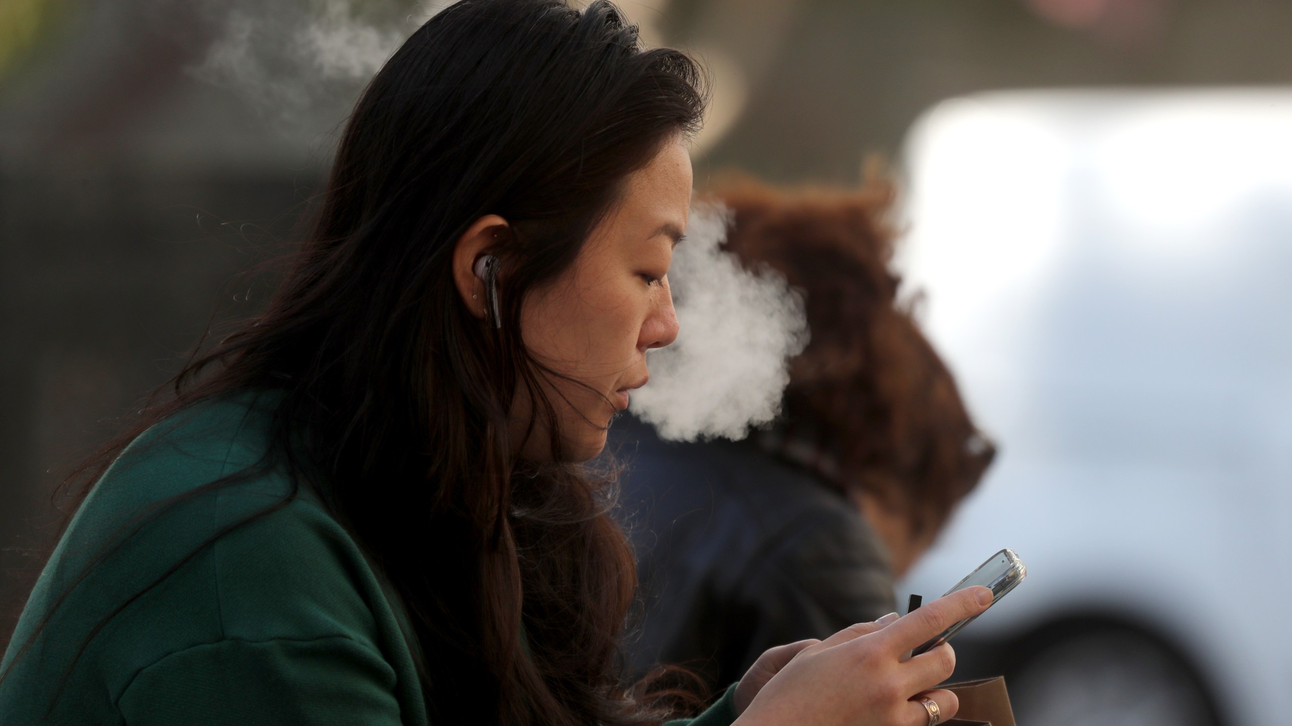 A pedestrian smokes an e-cigarette on Nov. 8, 2019, in San Francisco, California. (Justin Sullivan/Getty Images)