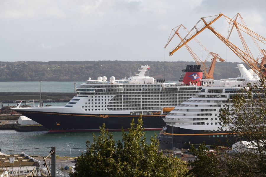 A picture taken on October 26, 2020 shows the Disney Dream liner (L), the third liner of the Disney Cruise Line, and the Disney Fantasy (R), owned by the Walt Disney Company cruise operator in Brest harbour, western France. (JEAN-FRANCOIS MONIER/AFP via Getty Images)