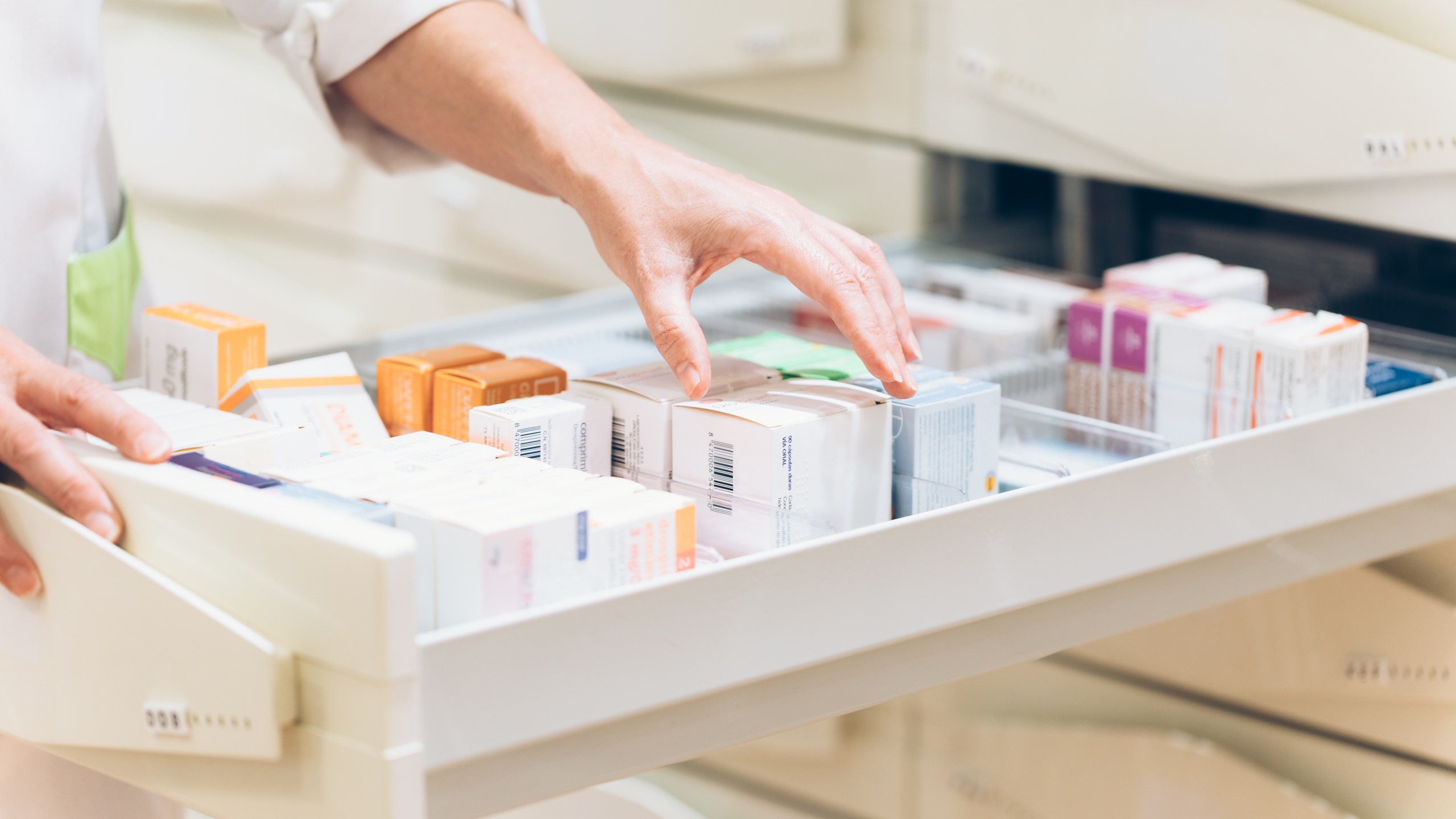 A pharmacist takes medication from a drawer in this undated file photo. (Getty Images)