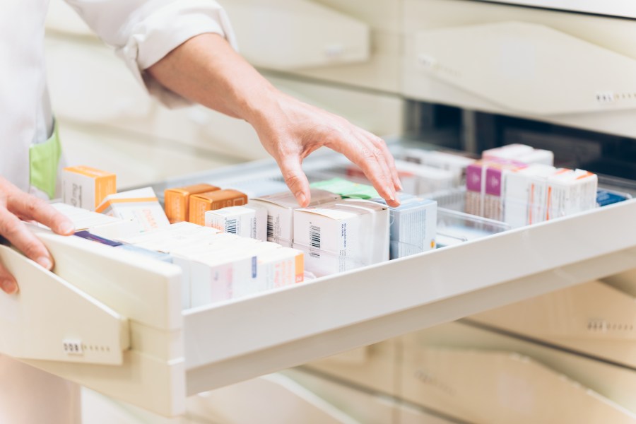 A pharmacist takes medication from a drawer in this undated file photo. (Getty Images)