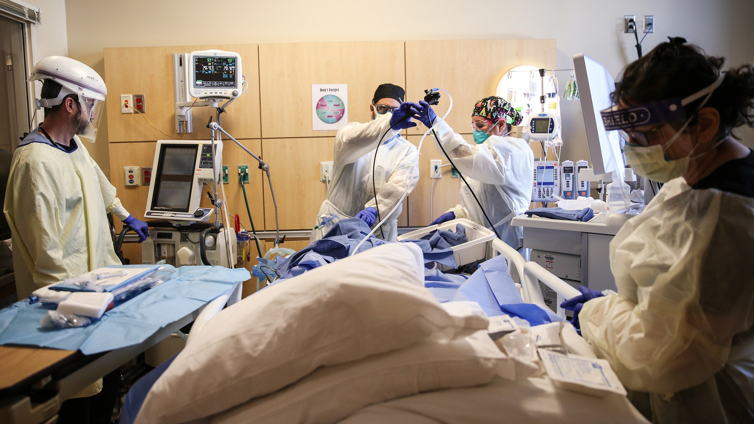 Clinicians perform a tracheostomy on a patient in a COVID-19 ICU in Mission Hills on Feb. 17, 2021 in Los Angeles. (Mario Tama/Getty Images)