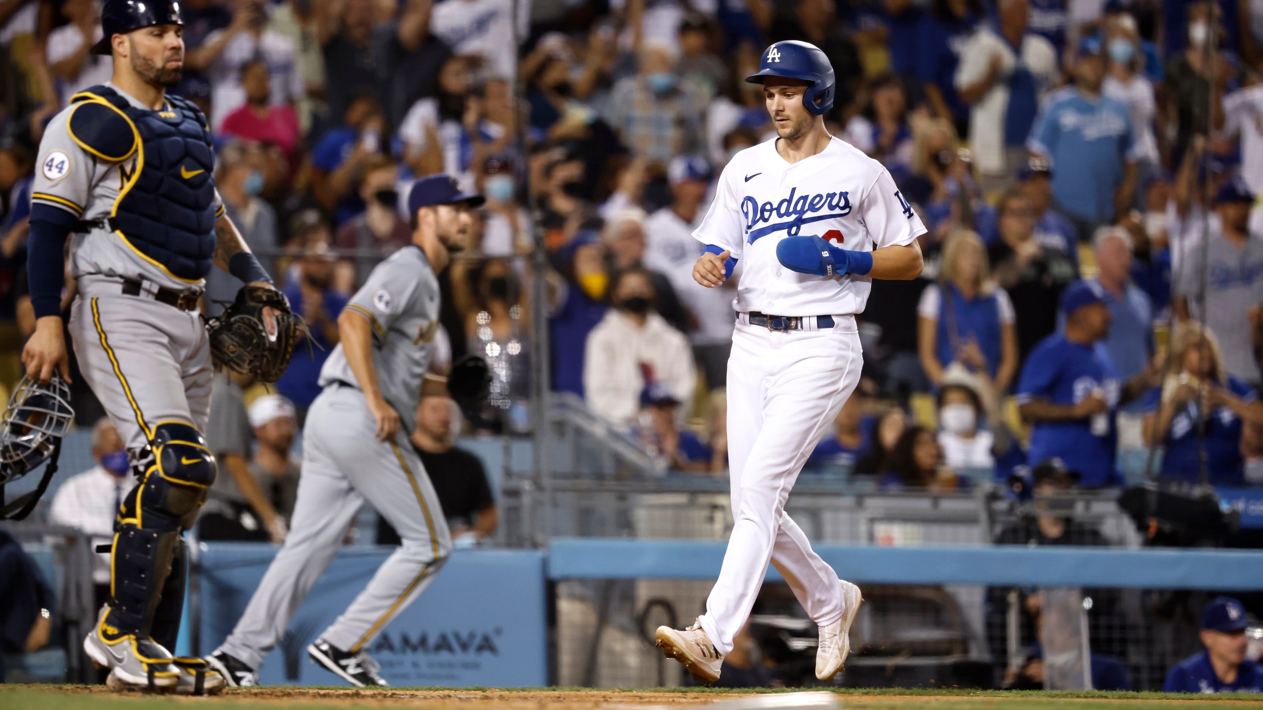 Trea Turner #6 of the Los Angeles Dodgers crosses home plate to score against the Milwaukee Brewers during the eighth inning at Dodger Stadium on October 02, 2021 in Los Angeles, California. (Photo by Michael Owens/Getty Images)