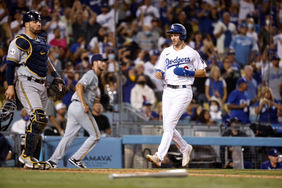 Trea Turner #6 of the Los Angeles Dodgers crosses home plate to score against the Milwaukee Brewers during the eighth inning at Dodger Stadium on October 02, 2021 in Los Angeles, California. (Photo by Michael Owens/Getty Images)