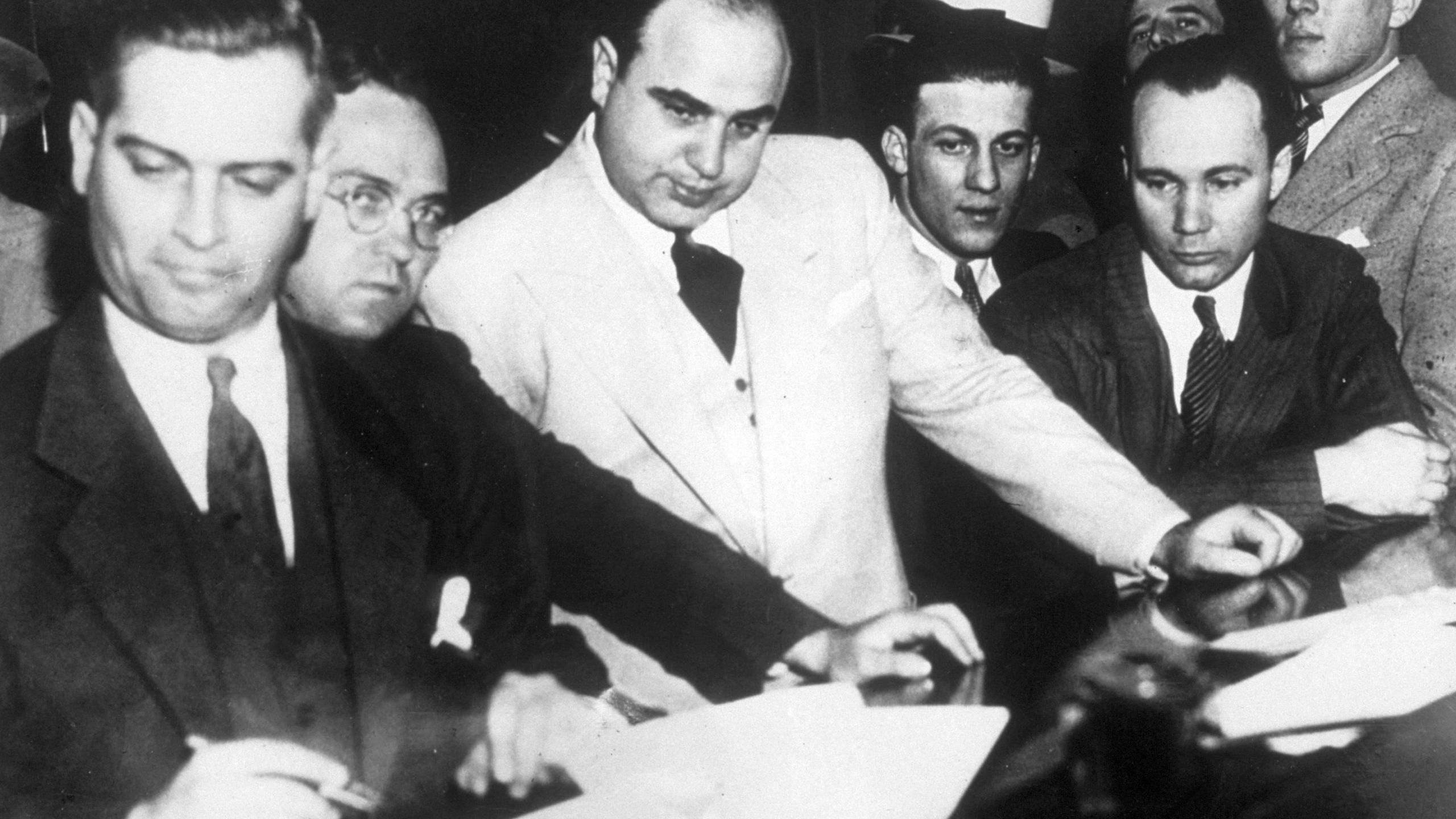 Al Capone (1899 - 1947) signing Uncle Sam's $50,000 bail bond in the Federal Building, Chicago. (Topical Press Agency/Getty Images)