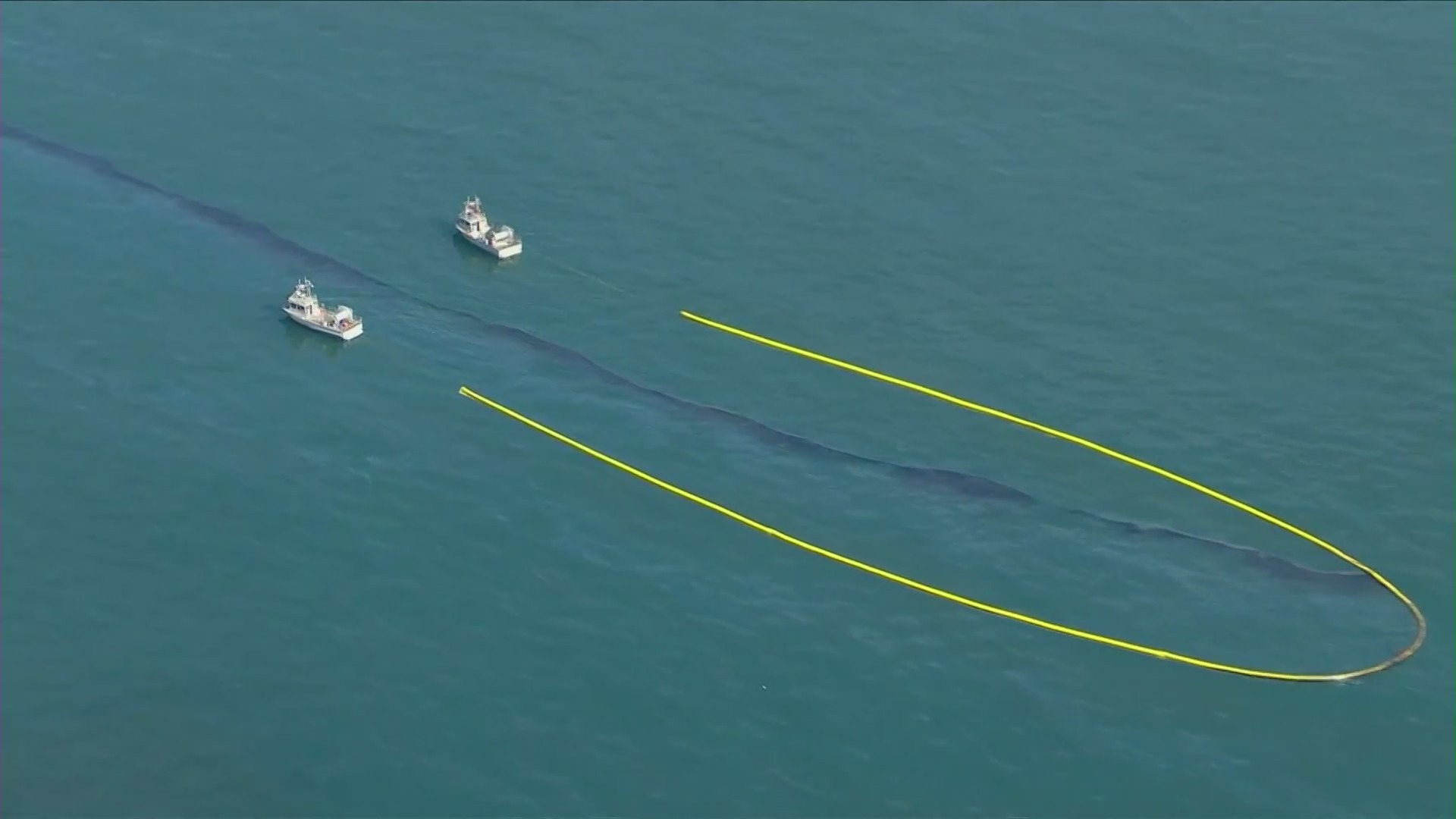 Boats attempt to remove oil from the Pacific Ocean on Oct. 3, 2021. (KTLA)