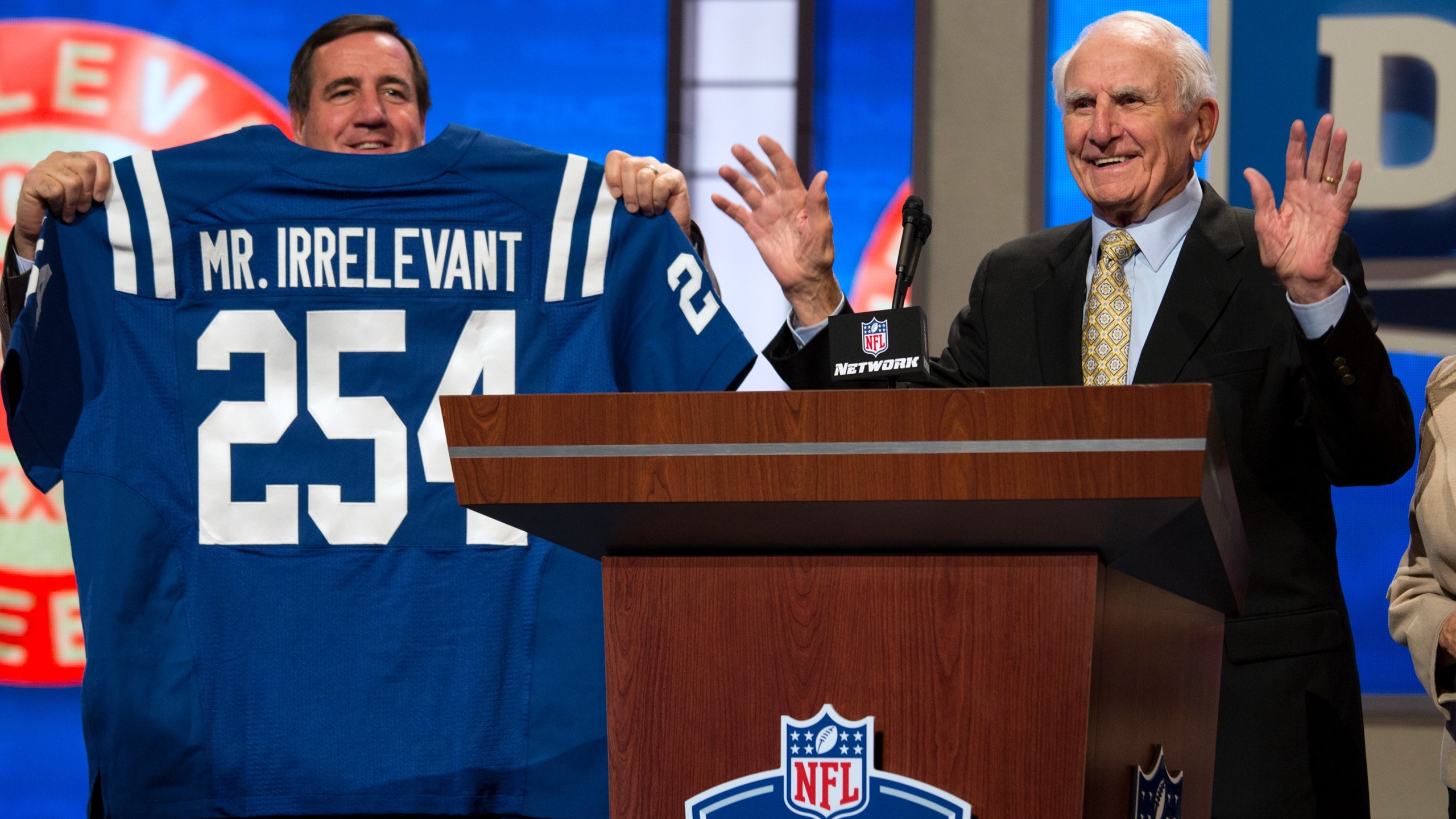 In this Saturday, April 27, 2013, photo, former NFL football receiver Paul Salata, right, announces the 254th overall pick of the NFL Draft at Radio City Music Hall in New York. Salata, who created the Mr. Irrelevant Award that honors the last selection of the NFL draft, after playing football at Southern California and in the NFL and Canadian Football League, died Saturday, Oct. 16, 2021. He was 94. (AP Photo/Craig Ruttle)