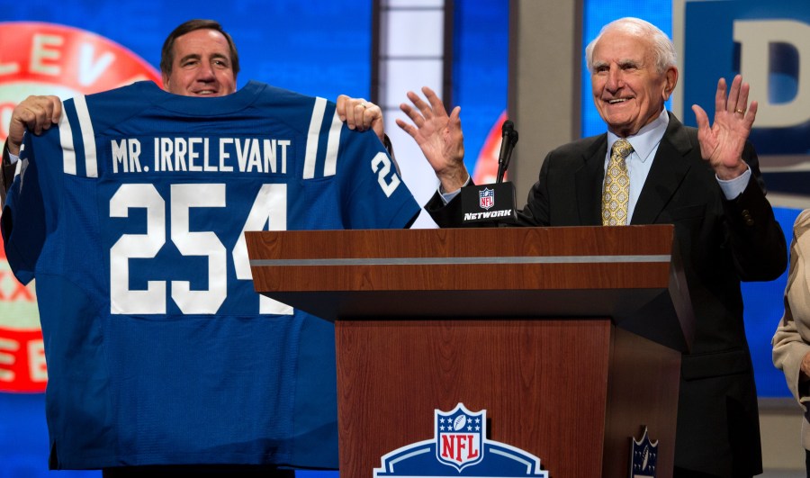 In this Saturday, April 27, 2013, photo, former NFL football receiver Paul Salata, right, announces the 254th overall pick of the NFL Draft at Radio City Music Hall in New York. Salata, who created the Mr. Irrelevant Award that honors the last selection of the NFL draft, after playing football at Southern California and in the NFL and Canadian Football League, died Saturday, Oct. 16, 2021. He was 94. (AP Photo/Craig Ruttle)