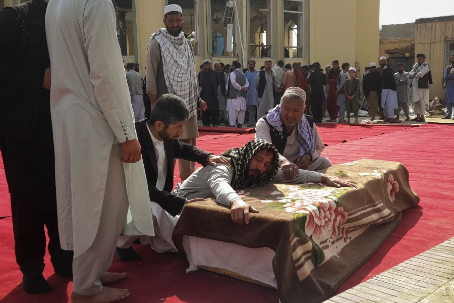 Relatives and residents attend a funeral ceremony for victims of a suicide attack at the Gozar-e-Sayed Abad Mosque in Kunduz, northern Afghanistan, Saturday, Oct. 9, 2021. The mosque was packed with Shiite Muslim worshippers when an Islamic State suicide bomber attacked during Friday prayers, killing dozens in the latest security challenge to the Taliban as they transition from insurgency to governance. (AP Photo/Abdullah Sahil)