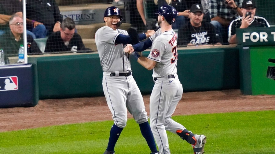 Houston Astros' Kyle Tucker, right, celebrates his two-run home run with Carlos Correa against the Chicago White Sox in the third inning during Game 3 of a baseball American League Division Series Sunday, Oct. 10, 2021, in Chicago. (AP Photo/Charles Rex Arbogast)