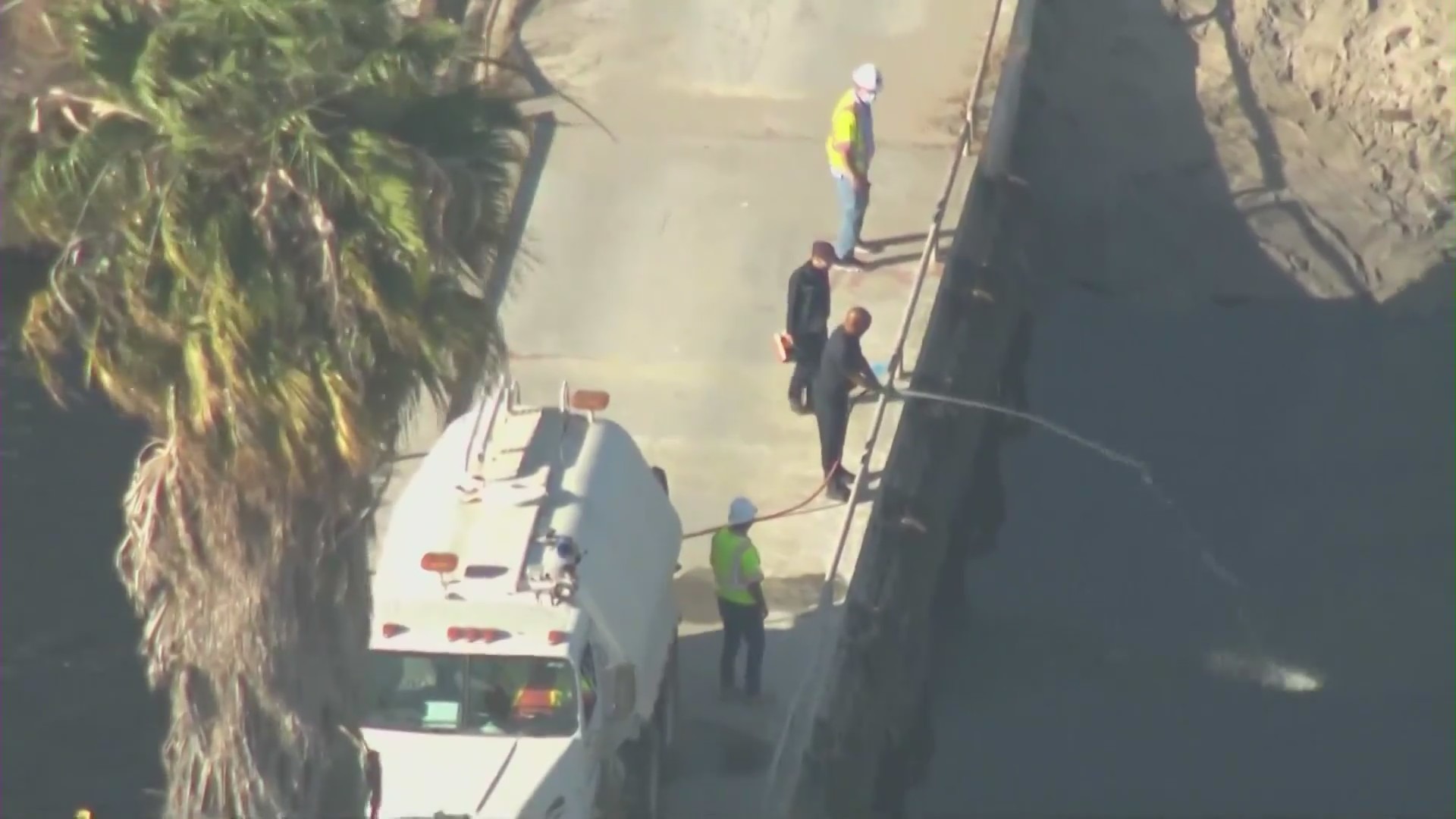 Public works officials work to deploy a deodorizer to assuage a foul smell coming from the Dominguez Channel in Carson on Oct. 15, 2021. (KTLA)