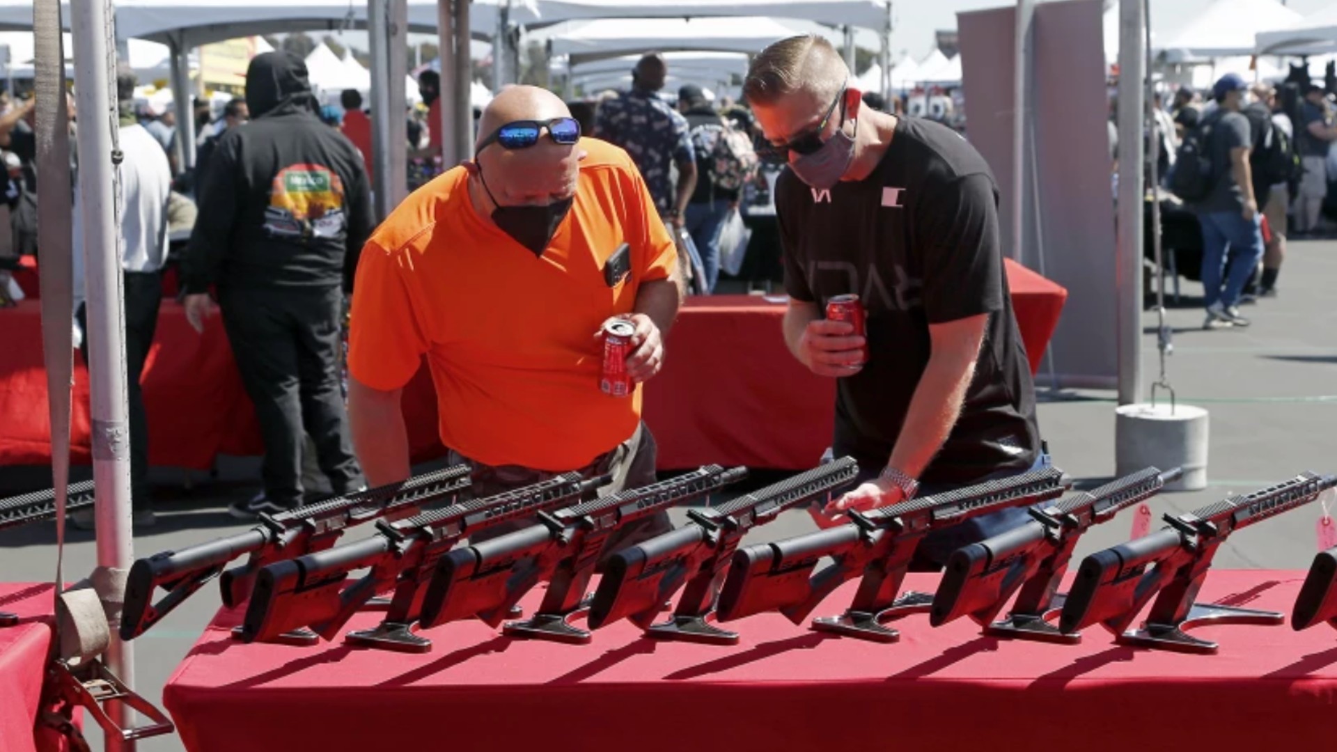 Gun enthusiasts check out sporting rifles in March during the Crossroads of the West Gun Show at the Orange County fairgrounds in Costa Mesa.(Kevin Chang / Times Community News)