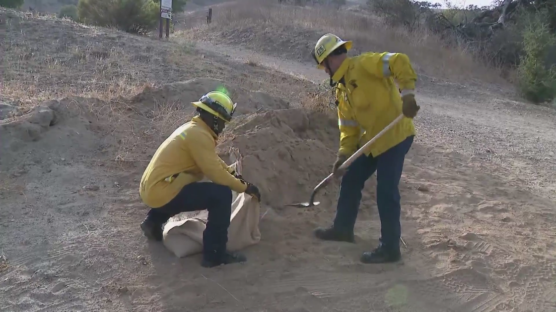 Firefighters demonstrate how to properly sandbag in this file photo. (KTLA)