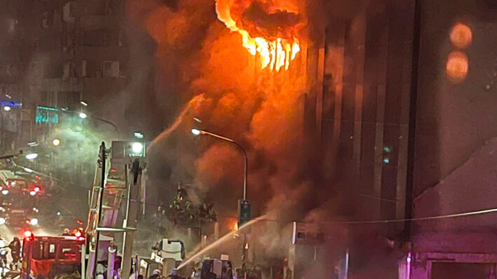 Firefighters battle a building fire in Kaohsiung, in southern Taiwan on Thursday, Oct. 14, 2021. (AP Photo/Huang Minghsiung)