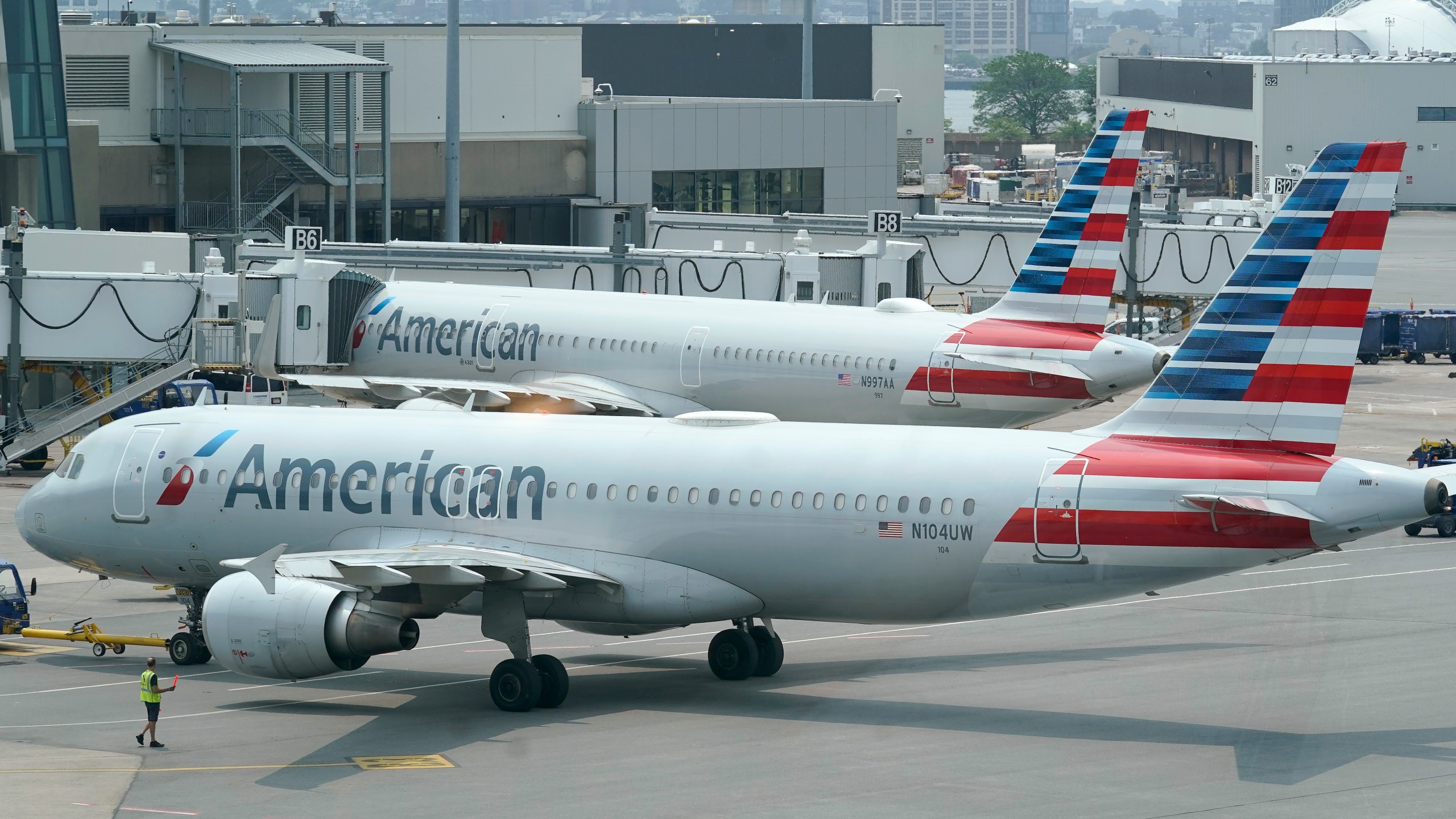 American Airlines passenger jets prepare for departure, Wednesday, July 21, 2021, near a terminal at Boston Logan International Airport, in Boston. American Airlines is still trying to dig out from under a blizzard of cancelled flights over the last few days. By midday Monday, Nov. 1, American had canceled more than 350 flights. It's the fourth straight day of major disruptions at American, which canceled more than 1,000 flights on Sunday.(AP Photo/Steven Senne)