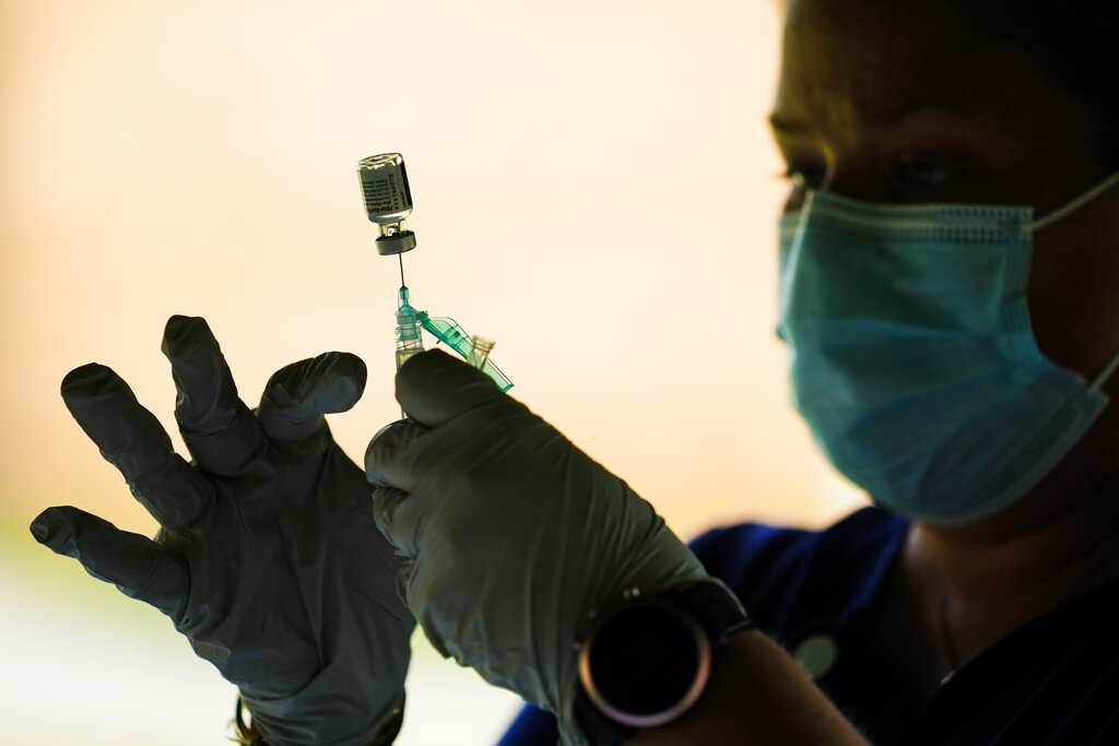 In this Sept. 14, 2021, file photo, a syringe is prepared with the Pfizer COVID-19 vaccine at a clinic at the Reading Area Community College in Reading, Pa. (AP Photo/Matt Rourke, File)