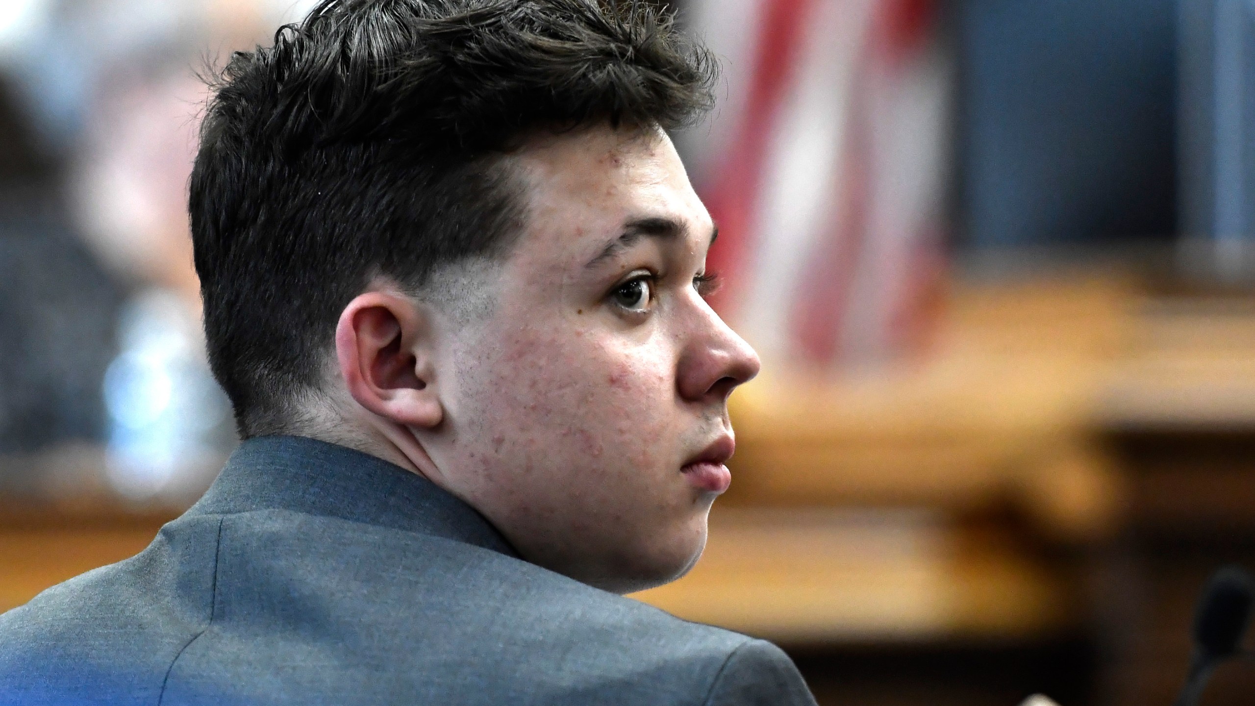 Kyle Rittenhouse looks back at the potential juror pool during the jury selection process at the Kenosha County Courthouse in Kenosha, Wis., Monday, Nov. 1, 2021. Rittenhouse is accused of killing two people and wounding a third during a protest over police brutality in Kenosha, last year. (Sean Krajacic/The Kenosha News via AP, Pool)