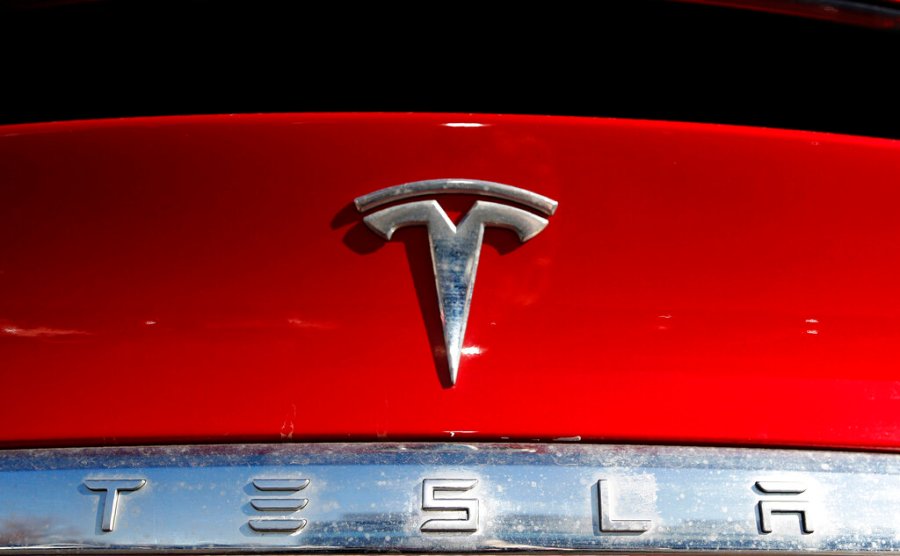 The Tesla company logo sits on an unsold 2020 Model X at a Tesla dealership in Littleton, Colo., on Feb. 2, 2020. (AP Photo/David Zalubowski, File)