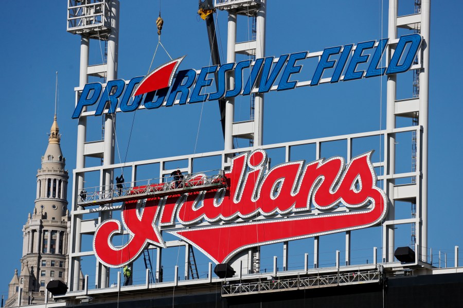 Workers begin to remove the Cleveland Indians sign from above the scoreboard at Progressive Field, on Nov. 2, 2021. (Ron Schwane/Associated Press)