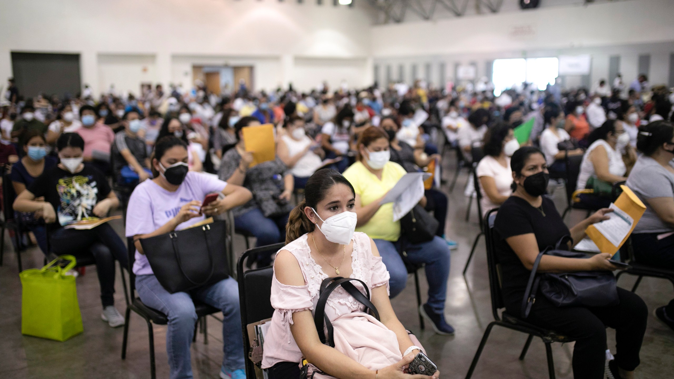 Education workers wait for their jab of the single-dose CanSino COVID-19 vaccine during a vaccination drive at the World Trade Center in Boca del Rio, Veracruz state, Mexico, April 20, 2021. (AP Photo/Felix Marquez, File)