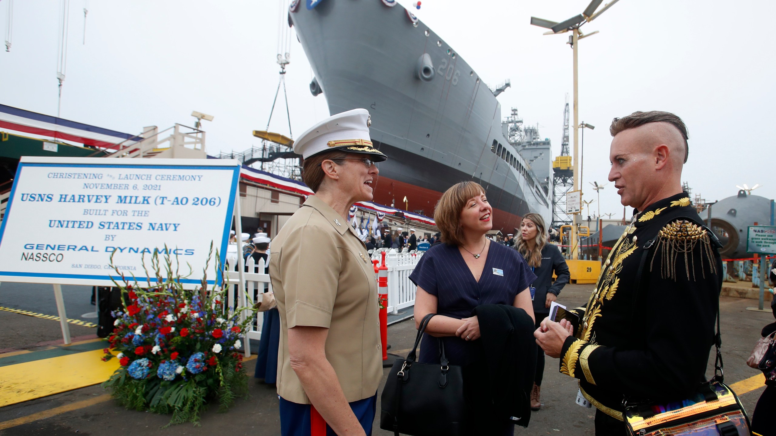 USMC Colonel Alison Thompson, left, talks with Jenn Onofrio, center, a White House Fellow to the Secretary of the Navy and Patrik Gallineaux, right, of the Richmond/Ermet Aid Foundation prior to the launching of the USNS Harvey Milk, a fleet replenishment oiler ship named after the first openly gay elected official, Saturday, Nov. 6, 2021 in San Diego. The Navy ship is the second of six vessels in the Navy's John Lewis-class program, second to the USNS John Lewis. (AP Photo/Alex Gallardo)