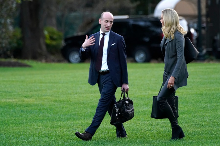 White House press secretary Kayleigh McEnany and White House senior adviser Stephen Miller walk across the South Lawn before boarding Marine One with President Donald Trump at the White House in Washington, on Oct. 20, 2020. (AP Photo/Andrew Harnik, File)