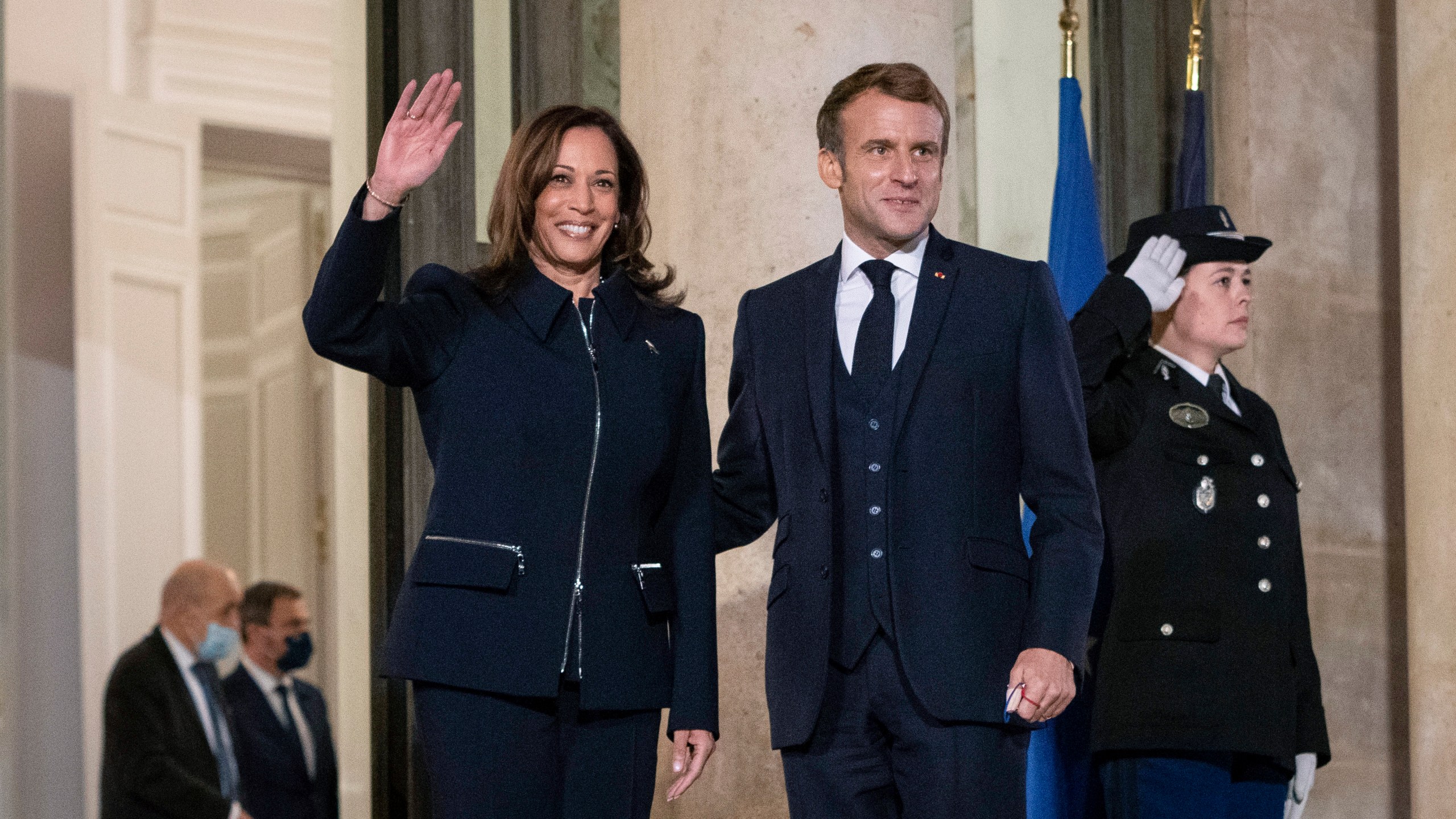 French President Emmanuel Macron stands next to Vice President Kamala Harris as she waves before a bilateral meeting at Élysée Palace in Paris, France on Nov. 10, 2021. (Sarahbeth Maney/The New York Times via AP, Pool)