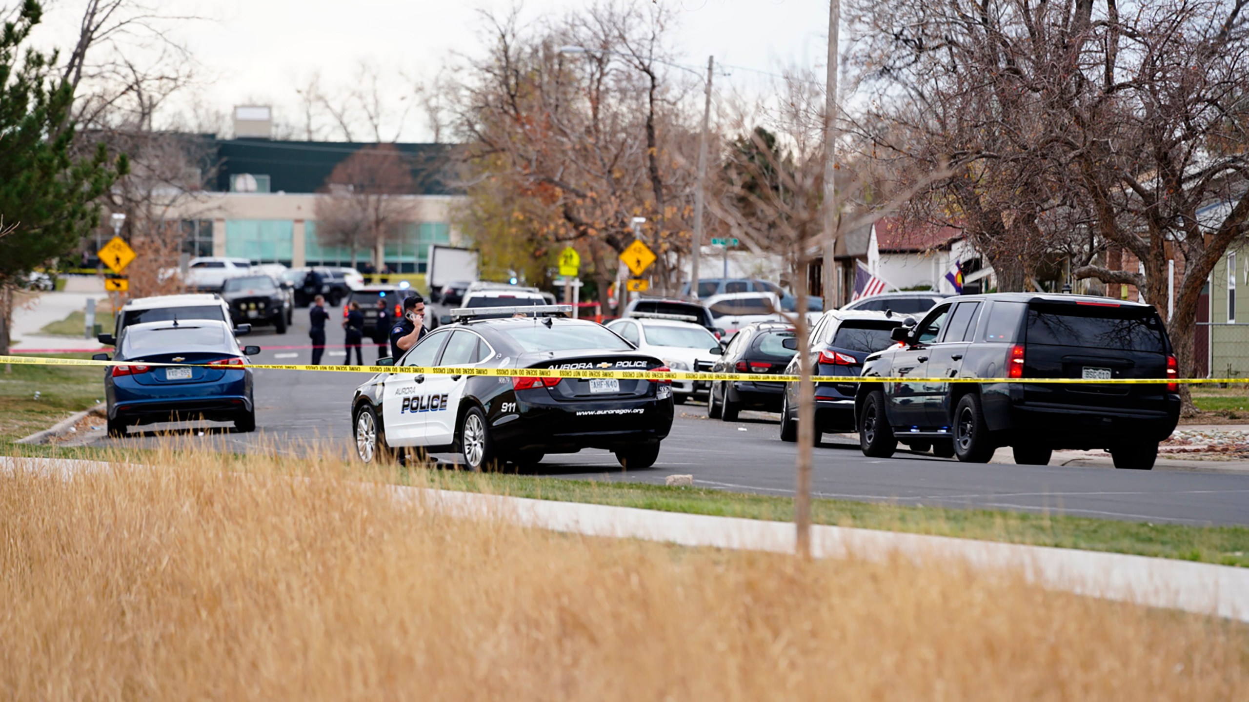 Law enforcement officials survey the scene of a shooting in which six teenagers were injured in a park in Aurora, Colo. on Nov. 15, 2021. (Philip B. Poston/Sentinel Colorado via AP)