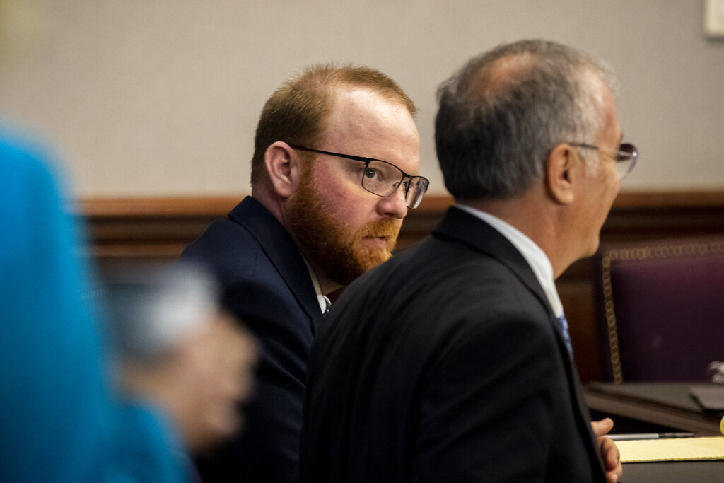 Travis McMichael, center, listens to his attorney Bob Rubin, right, during his trial in the Glynn County Courthouse, Tuesday, Nov. 16, 2021, in Brunswick, Ga. (AP Photo/Stephen B. Morton, Pool)