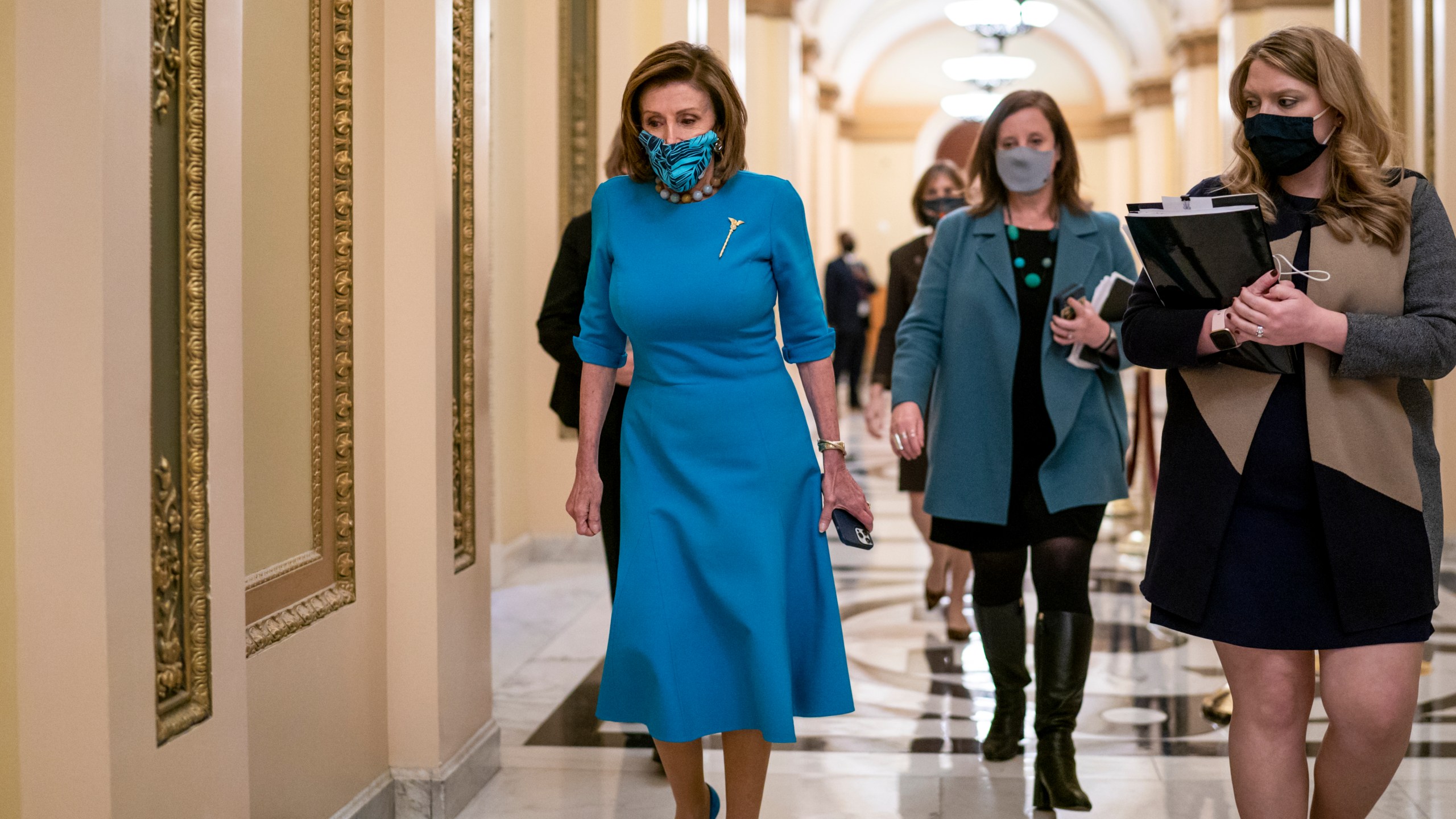 Speaker of the House Nancy Pelosi, D-Calif., leaves the chamber after midnight during a lengthy floor speech by House Minority Leader Kevin McCarthy, R-Calif., who disrupted a planned vote on President Joe Biden's domestic agenda, the Build Back Better Act, at the Capitol in Washington, early Friday, Nov. 19, 2021. (AP Photo/J. Scott Applewhite)