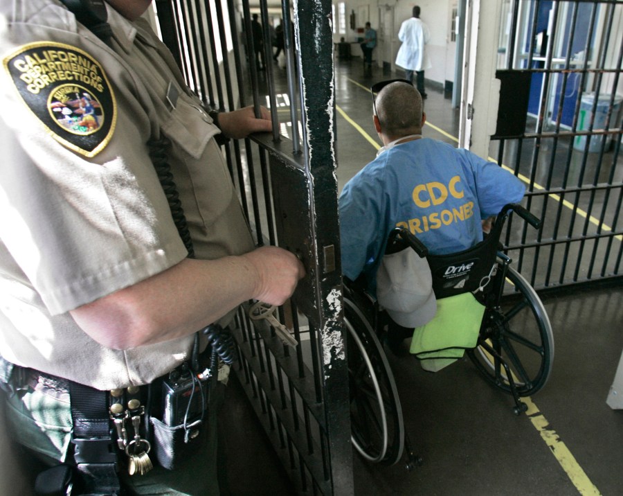 A wheelchair-bound inmate wheels himself through a checkpoint at the California Medical Facility in Vacaville on April 9, 2008. California corrections officials have begun limiting medical parole only to inmates so ill they are on ventilators. (Rich Pedroncelli/Associated Press)