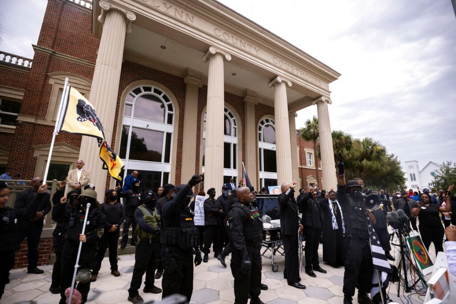 Dozens of Black Lives Matter and Black Panther protesters gather outside the Glynn County Courthouse where the trial of Travis McMichael, his father, Gregory McMichael, and William "Roddie" Bryan is held, Monday, Nov. 22, 2021, in Brunswick, Ga. (AP Photo/Stephen B. Morton)