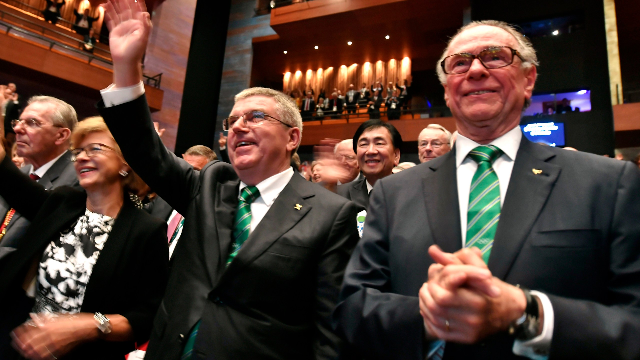 Then President of the Rio 2016 Olympic Organizing Committee Carlos Arthur Nuzman, right, and International Olympic Committee President Thomas Bach, second right, applaud during the opening ceremony of the 129th International Olympic Committee session, in Rio de Janeiro on August 1, 2016, ahead of the Rio 2016 Olympic Games. (Fabrice Coffrini/Pool Photo via AP, File)