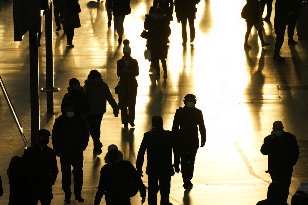 People pass through Waterloo train station, in London, during the morning rush hour, Monday, Nov. 29, 2021. (AP Photo/Matt Dunham)