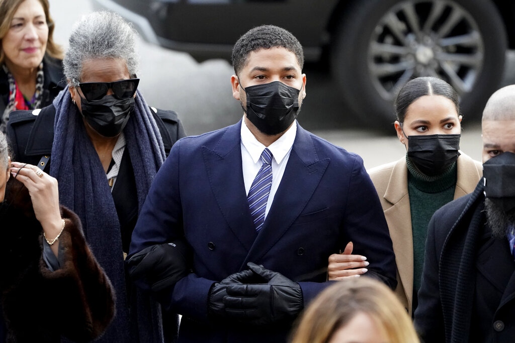 Actor Jussie Smollett walks with family members as they arrive Monday, Nov. 29, 2021, at the Leighton Criminal Courthouse for jury selection at his trial in Chicago. (AP Photo/Charles Rex Arbogast)