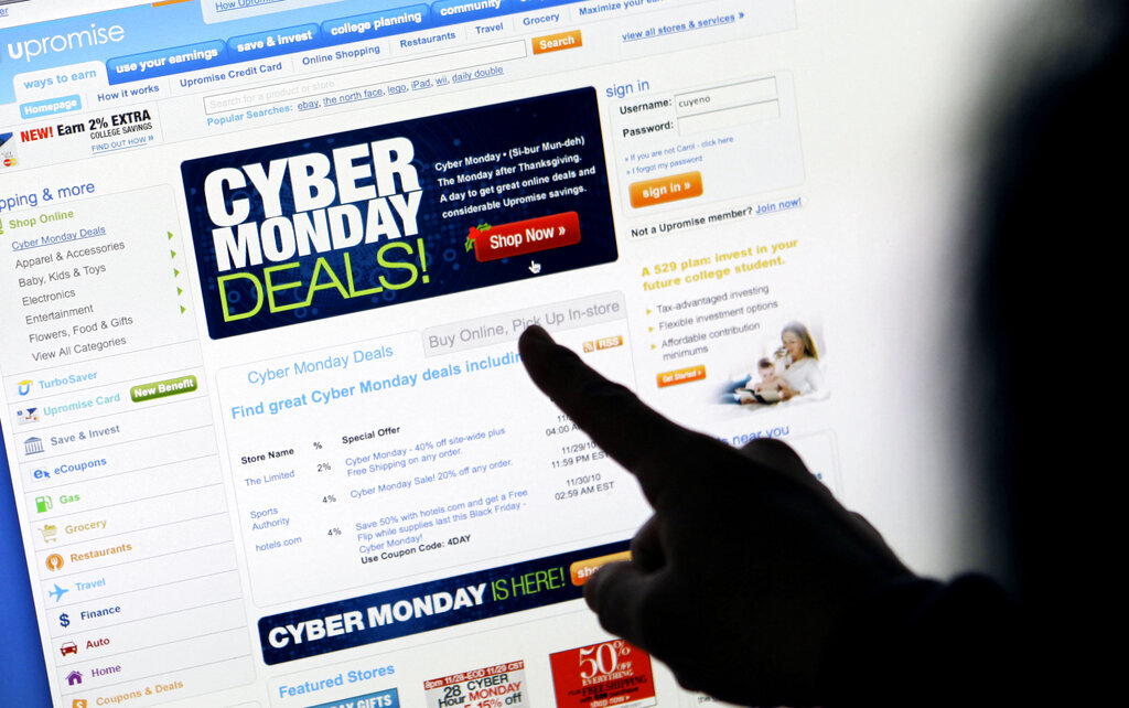 In this Nov. 29, 2010 file photo, a consumer looks at Cyber Monday sales on her computer at her home in Palo Alto, Calif. (AP Photo/Paul Sakuma, File)