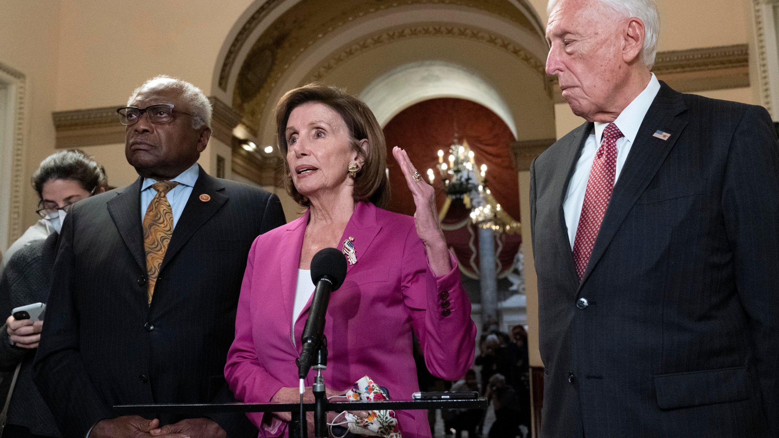 Speaker of the House Nancy Pelosi, D-Calif., accompanied by House Majority Whip James Clyburn, D-S.C., left and House Majority Leader Steny Hoyer D-Md. speaks to reporters at the Capitol in Washington, Friday, Nov. 5, 2021, as the House is considering President Joe Biden's $1.85 trillion-and-growing domestic policy package. (AP Photo/Jose Luis Magana)