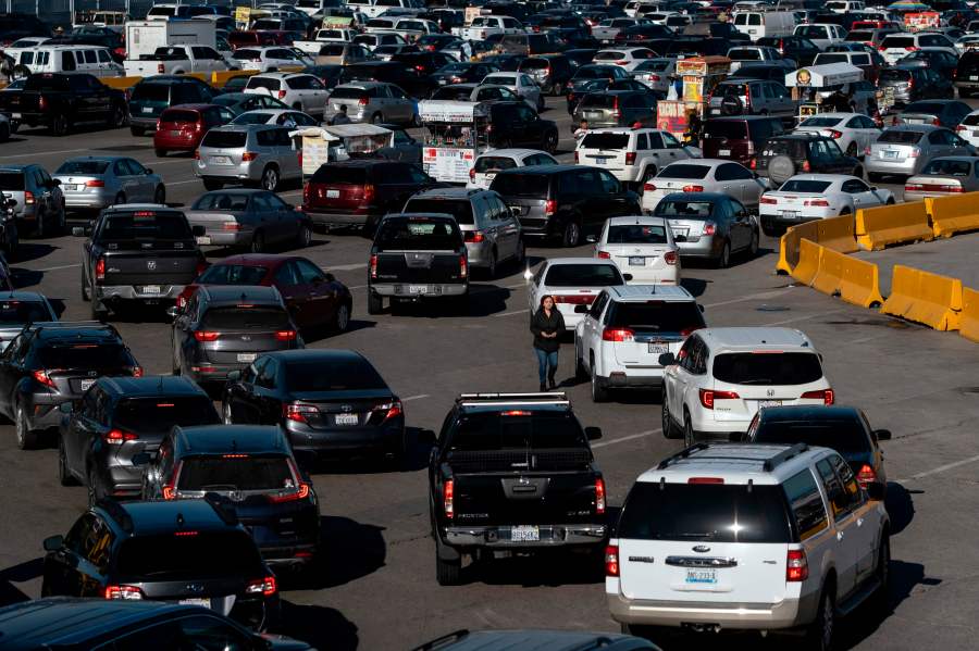 This Feb. 13, 2020 file photo shows cars lining up to cross the U.S.-Mexico border to San Diego at San Ysidro port of entry, in Tijuana, Baja California state, Mexico. (GUILLERMO ARIAS/AFP via Getty Images)