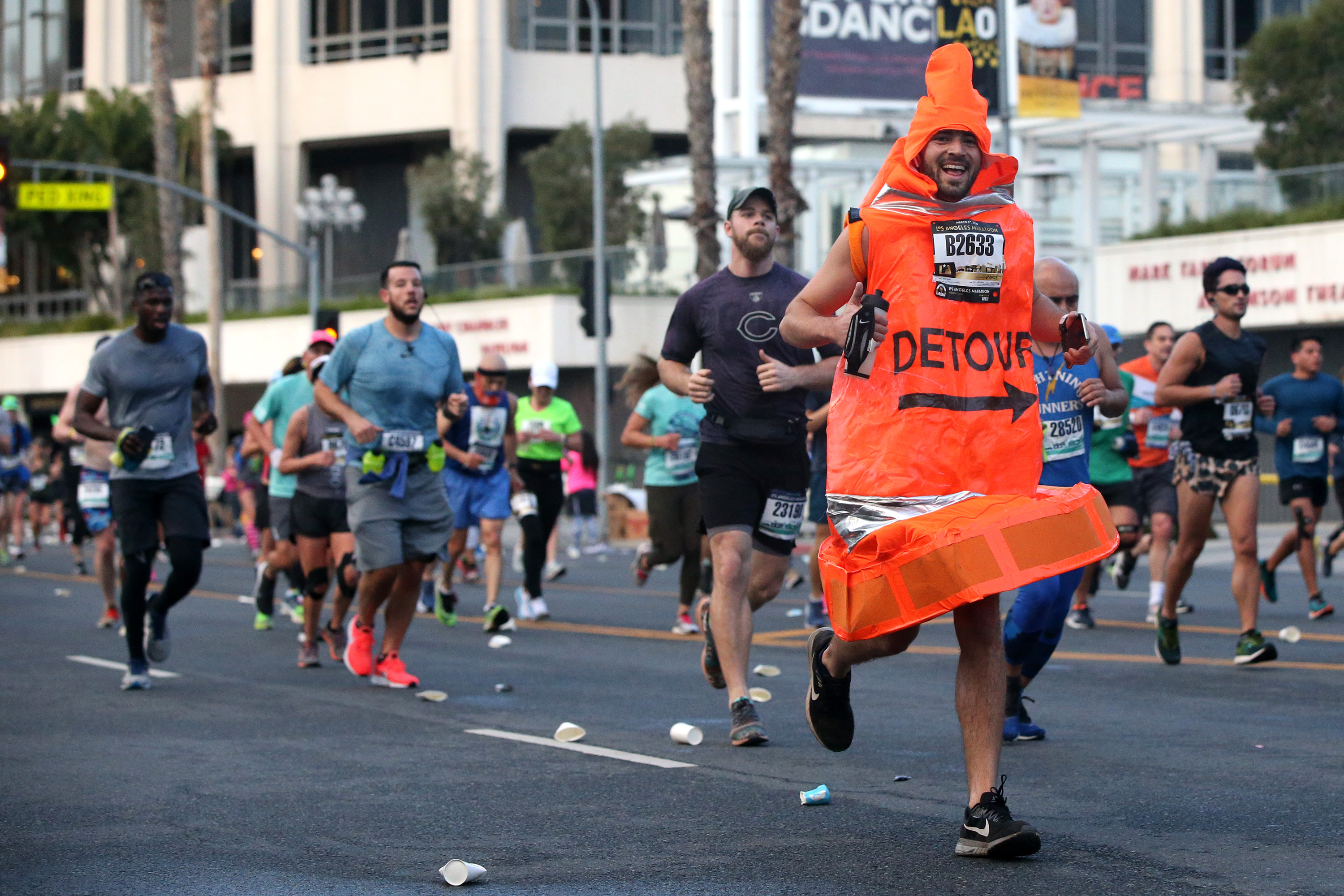 A man dressed as a traffic cone runs on Grand Street during the 2020 Los Angeles Marathon on March 8, 2020 in Los Angeles. (Katharine Lotze/Getty Images)