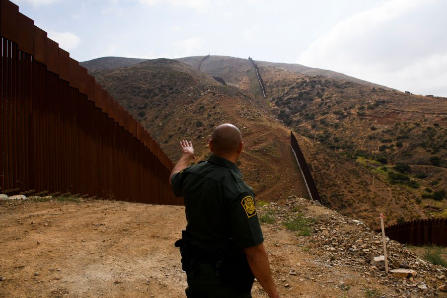 A U.S. Border Patrol agent shows an incomplete section of a border wall on a hillside along the U.S.-Mexico border between San Diego and Tijuana on May 10, 2021 in the Otay Mesa area. (PATRICK T. FALLON/AFP via Getty Images)