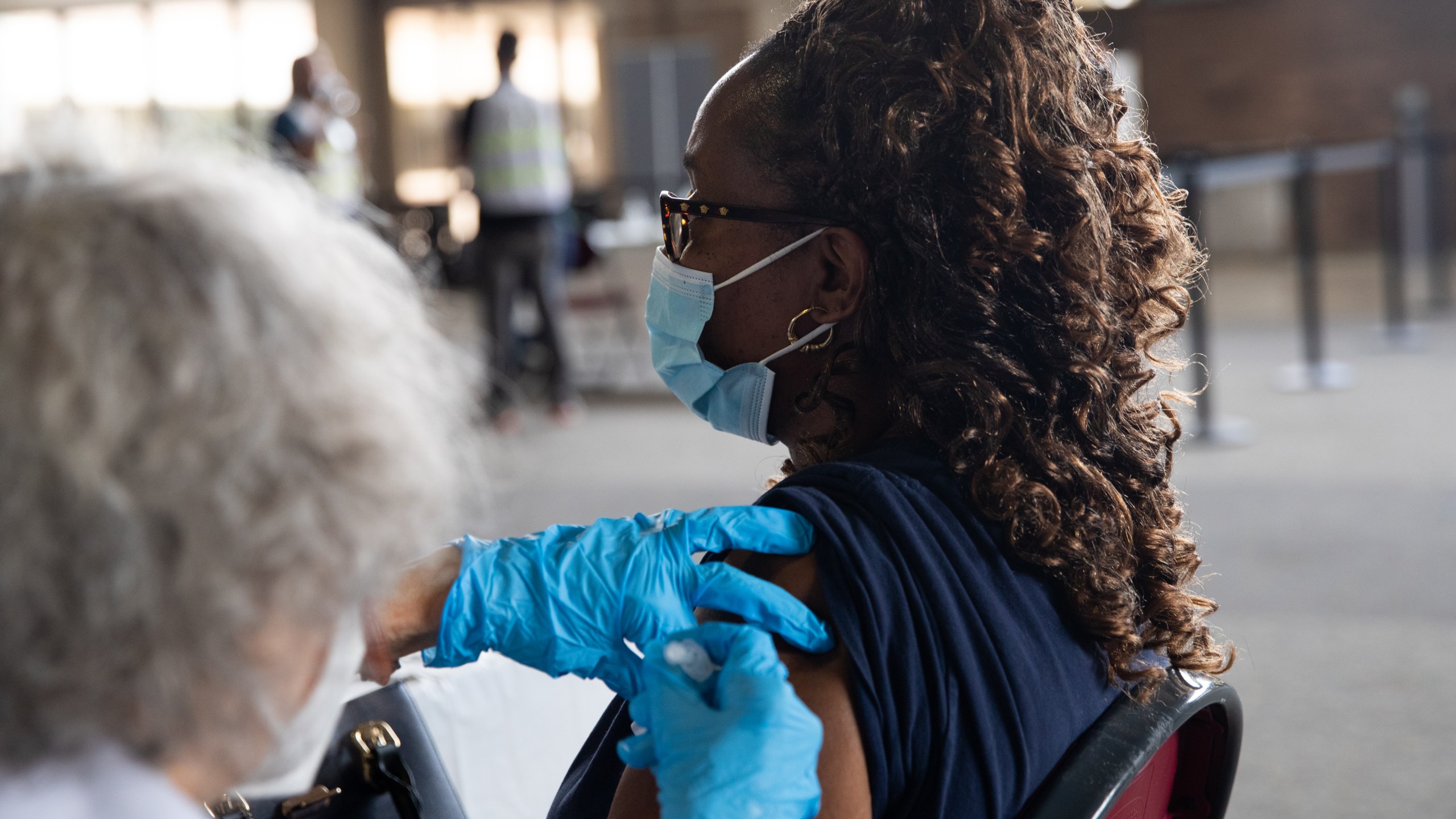 A woman receives her booster dose of the Pfizer COVID-19 vaccine on Aug. 24, 2021 in Southfield, Michigan. (Emily Elconin/Getty Images)