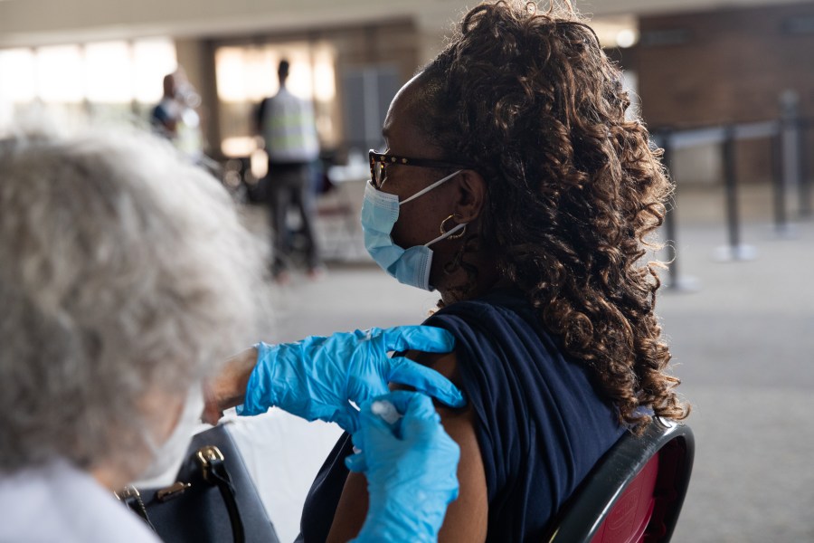 A woman receives her booster dose of the Pfizer COVID-19 vaccine on Aug. 24, 2021 in Southfield, Michigan. (Emily Elconin/Getty Images)