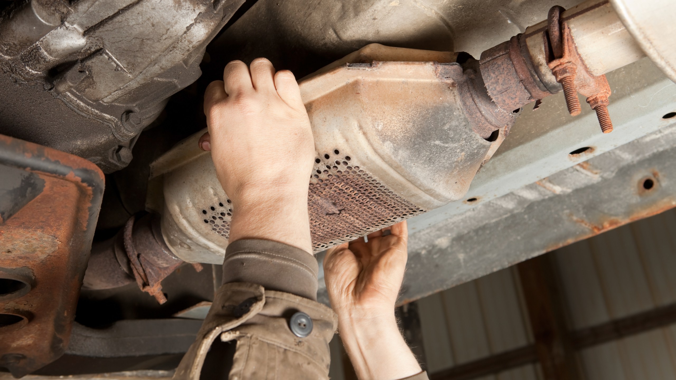 This file photo shows an SUV's catalytic converter is being removed at a salvage yard. (Getty Images)