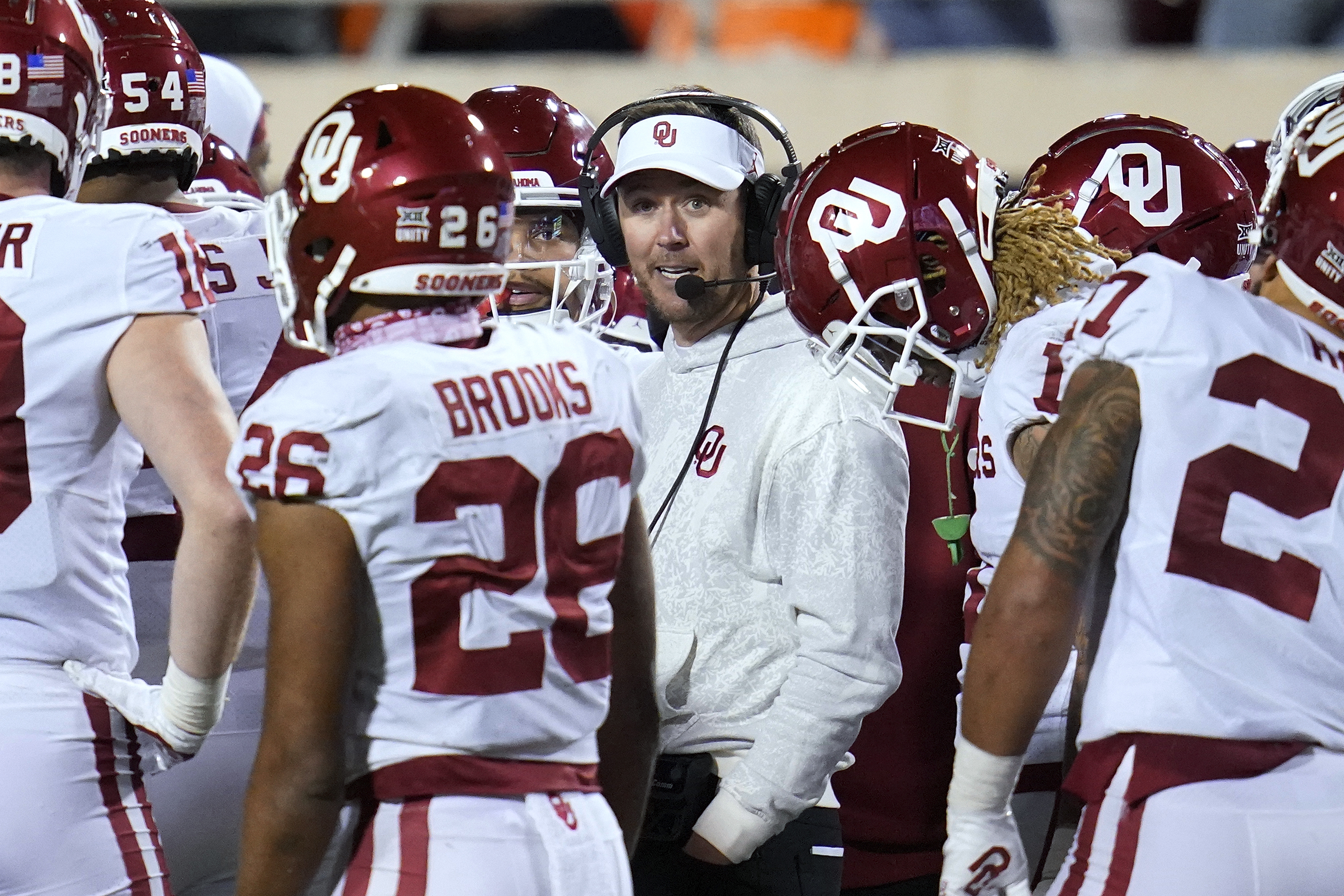 Oklahoma head coach Lincoln Riley talks with his players during the second half of an NCAA college football game against Oklahoma State, Saturday, Nov. 27, 2021, in Stillwater, Okla. (AP Photo/Sue Ogrocki)