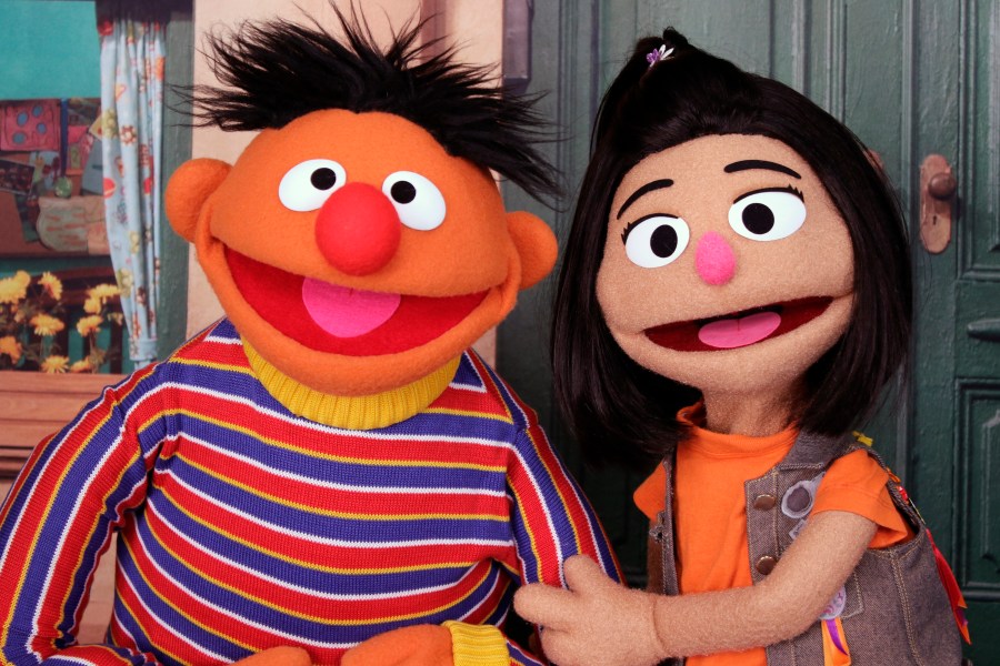 Ernie, a muppet from the popular children's series "Sesame Street," appears with new character Ji-Young, the first Asian American muppet, on the set of the long-running children's program in New York on Nov. 1, 2021. Ji-Young is Korean American and has two passions: rocking out on her electric guitar and skateboarding. (AP Photo/Noreen Nasir)